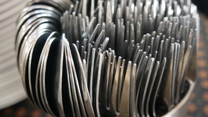 Close-up of a bunch of metal spoons on a table. Food equipment in restaurant