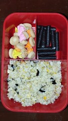A child's meal consisting of rice, side dishes and fruit. Healthy children's food menu for school supplies and fulfill children's nutrition. Bento rice