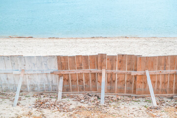 Wooden plank fencing on Danube river sandy beach