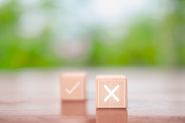 check right and wrong on the wood block. concept decide to choose vote. yes or no decisions, and business options for difficult situations in dilemma. Select the wrong mark sign