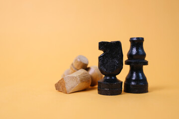 Black and white chess pieces on yellow background