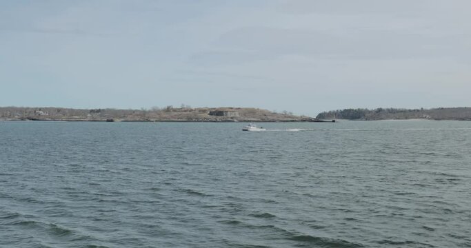Boat travelling across the choppy waters of the Atlantic Ocean during a beautiful spring day.