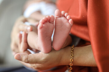 Baby feet in mother hands. Beautiful conceptual image of maternity.