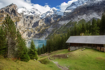 Oeschinnensee, wooden chalet and Swiss Alps, Switzerland.