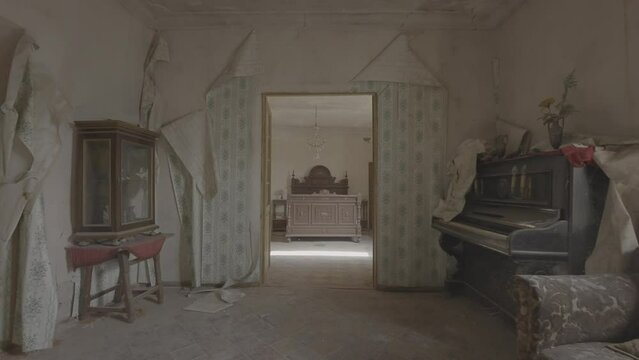 Interior of an elegant abandoned palace with furniture, armchair, piano and wooden bed (S-Log 3, Travelling movement, ProRes 422HQ, 4K)