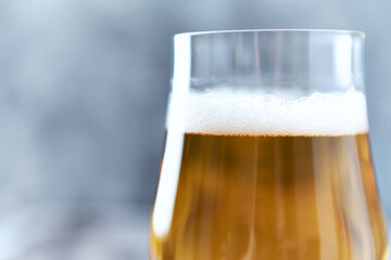 Glass of beer on bright wooden background. Copy space.	