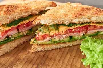 Close-up of the sandwiches. Appetizing sandwiches on a wooden board. 