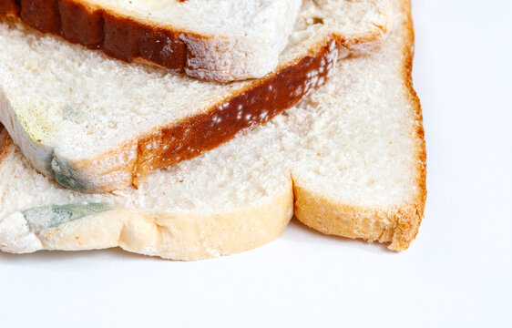 close up of mold forming on sliced white bread, abstract crop
white bread slices with mold isolated on white
