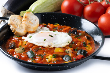 Vegetable pisto manchego with tomatoes, zucchini, peppers, onions,eggplant and egg, served in...