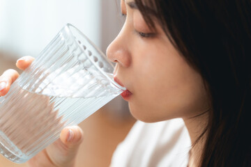 close up shot of a woman drinking water from a glass. Healthy, food and drink concept.