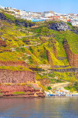 Fira or Thira, Greece panoramic view in Santorini Island with white houses on high volcanic rocks, donkey path, cable car old port