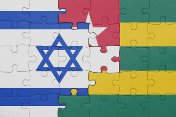 puzzle with the colourful national flag of israel and flag of togo .