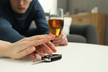 Woman stopping drunk man from taking car keys, closeup. Don't drink and drive concept