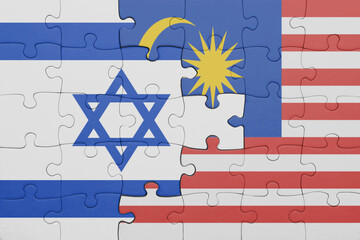 puzzle with the colourful national flag of israel and flag of malaysia .