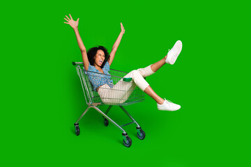 Full size photo of nice young woman sit inside pushcart wear top isolated on green color background