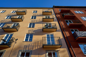 Background of the city of buildings of the architecture of the past. Rows of walls and balconies in...