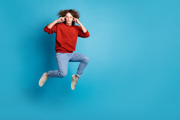 Full length photo of handsome thoughtful guy wear red sweater jumping high fingers temples emtpy...