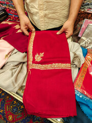 An unidentified seller demonstrates beautiful, finest, handmade cashmere shawls. Kathmandu