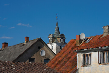 Obraz premium View of the tiled roofs of houses in the historical center of the city. Sunny weather.