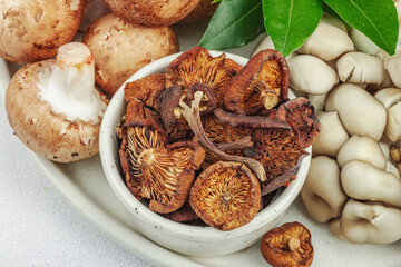 Assortment of various mushrooms - fresh, dried and pickled. Oyster, cremini, porcini and shiitake