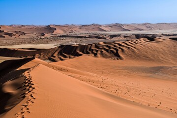 Scenic view of a dry desert landscape in Africa, featuring sand dunes