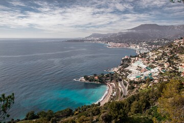 a bay with a town on the shore and a green hillside in the background