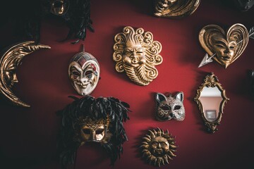 Closeup of masks hanging on a red wall