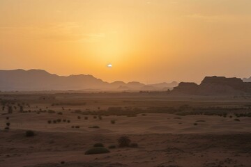 the sun rises over the desert land with hills in the distance