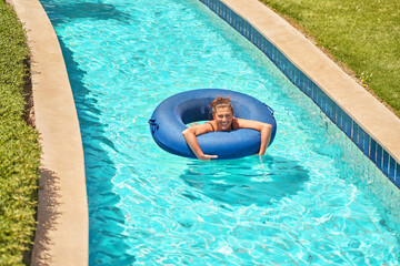 Picture of woman swim on water tube in pool