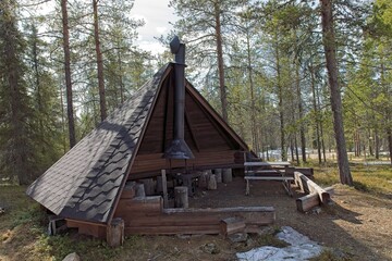 Wooden shelter and campfire at Tankavaara in cloudy spring weather, Sodankyl&auml;, Lapland, Finland.