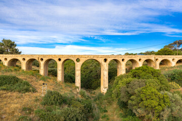 Obraz premium The stone bridge of Katouni built by British in Kythira Greece, with big arches and round openings.