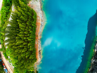 Aerial view of amazing pond in tropical rainforest with mountain rocks peak, Beautiful water surface in Phang Nga Thailand
