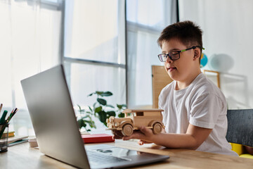 adorable boy with Down syndrome playing creatively with wooden toy on laptop at home.