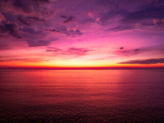 Aerial view sunset sky, Beautiful Light Sunset or sunrise over sea,Colorful dramatic majestic scenery sunset Sky, Amazing clouds and small waves in the ocean, Wonderful light cloud background