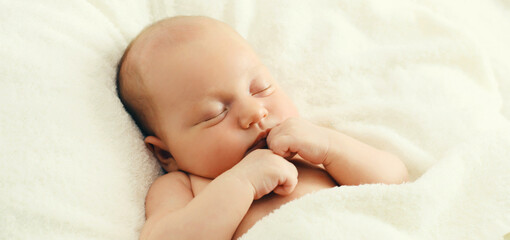 Portrait of infant sweet sleeping lying on white bed at home