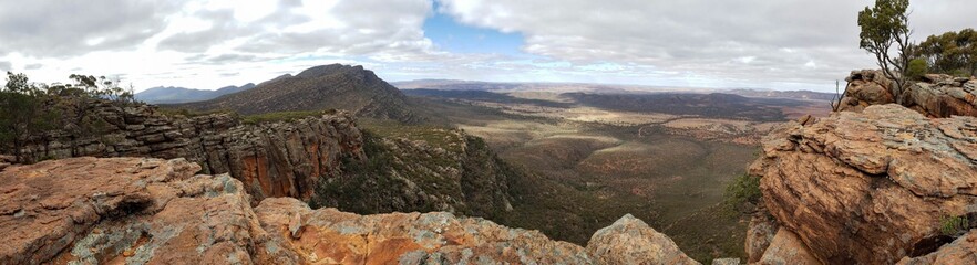 Majestic view of mountain peaks covered with lush evergreen trees against a cloudy sky