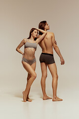 Athletic lifestyle. Full-length image of muscular man and sportive woman, young models posing in...