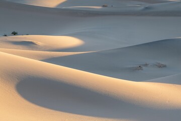 Beautiful view of desert landscape showcasing flat sand, sunset hues reflected on its surface