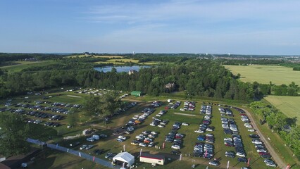 Aerial view of a parking lot with cars next to a cricket stadium © Wirestock