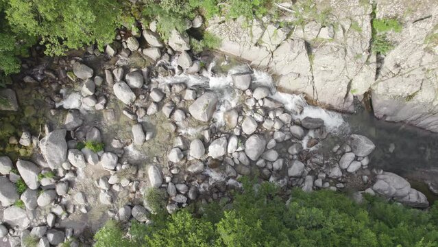 River and Waterfall Flowing Through Rocky Riverbed - Aerial Topdown