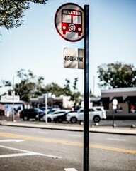 a red bus crossing sign and traffic sign on a pole