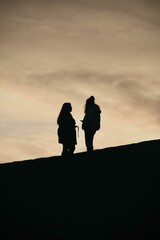 Silhouettes of people  illuminated by a warm, golden light