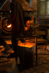 Foundry ladle with molten metal in workshop of metallurgical plant