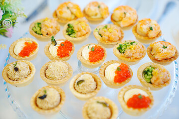 tartlets with pate, red caviar, shrimps and fish. Original snacks for the buffet. catering 