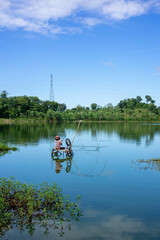 Traditional fisherman on a lake in Lombok, Indonesia, capturing the essence of serene rural life on...