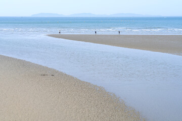 View of the seaside with the tourists on the beach