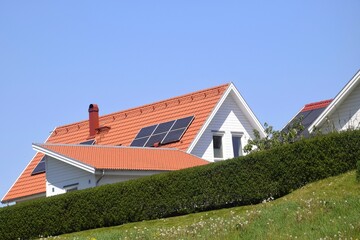Solar panels on the roof of a house. Alternative heating system and energy saving