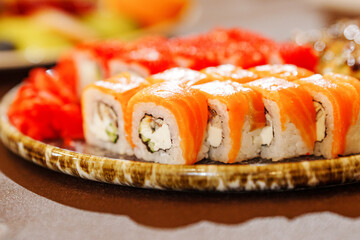 A large plate with rolls. A set of assorted rolls for the holiday. Ordering and delivery of Japanese cuisine.
