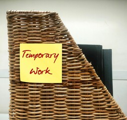 Folder filing box with note written TEMPORARY WORK, temporary employment job limited to a certain...