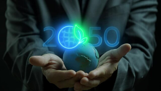 Net zero emissions by 2050 to change climate and net zero greenhouse gas emissions target. Sustainable development and green business concept. Businessman showing earth global model with net zero icon